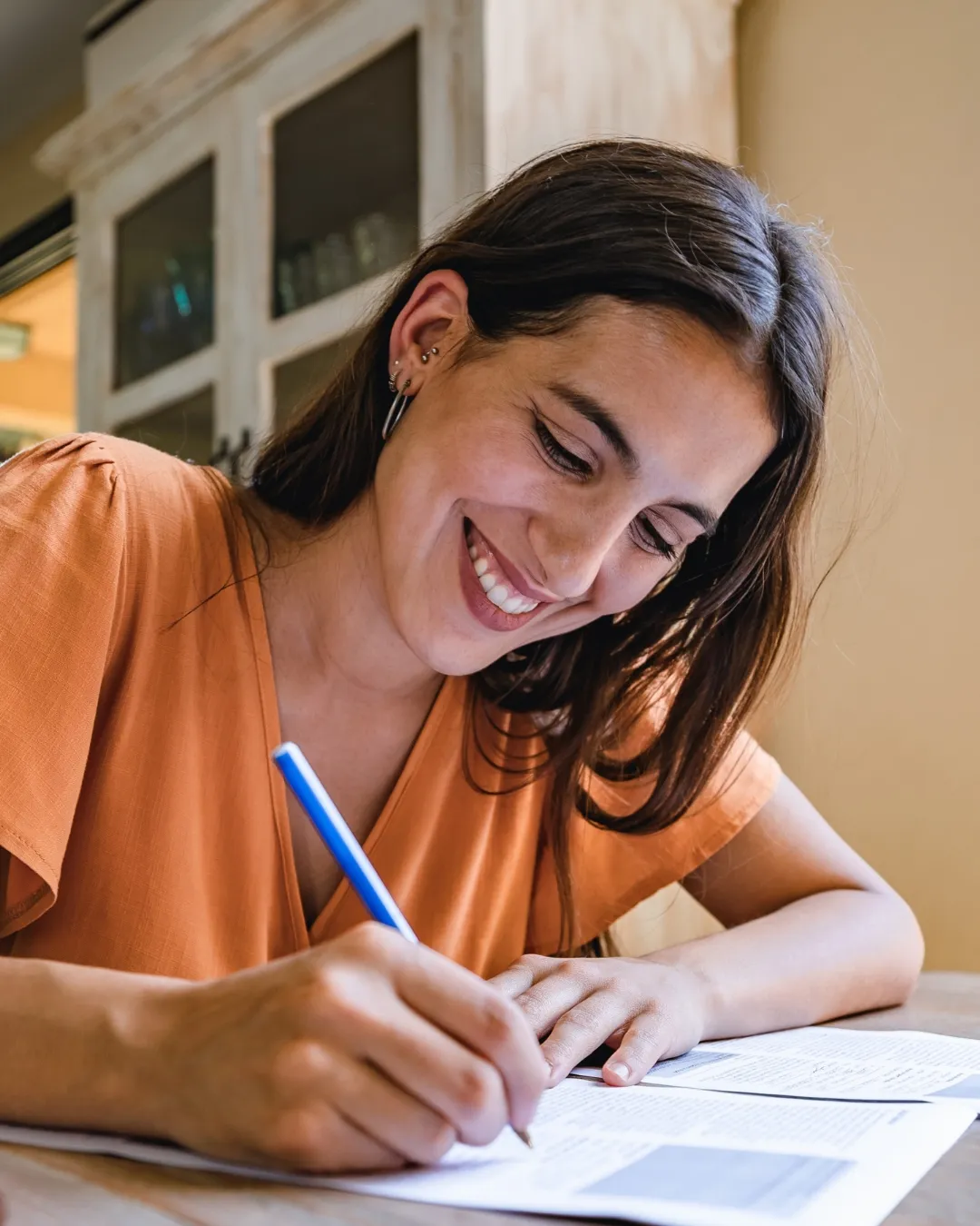A patient writing a consent form at a desk
